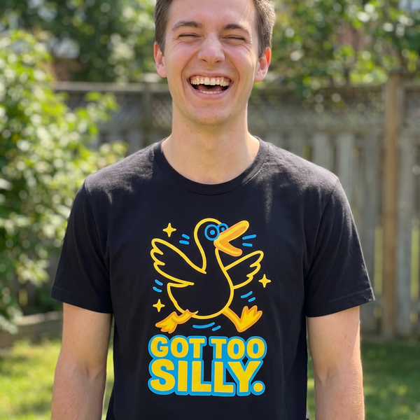 Guy mid-laugh in backyard wearing Got Too Silly goose meme tee, 1:1 lifestyle