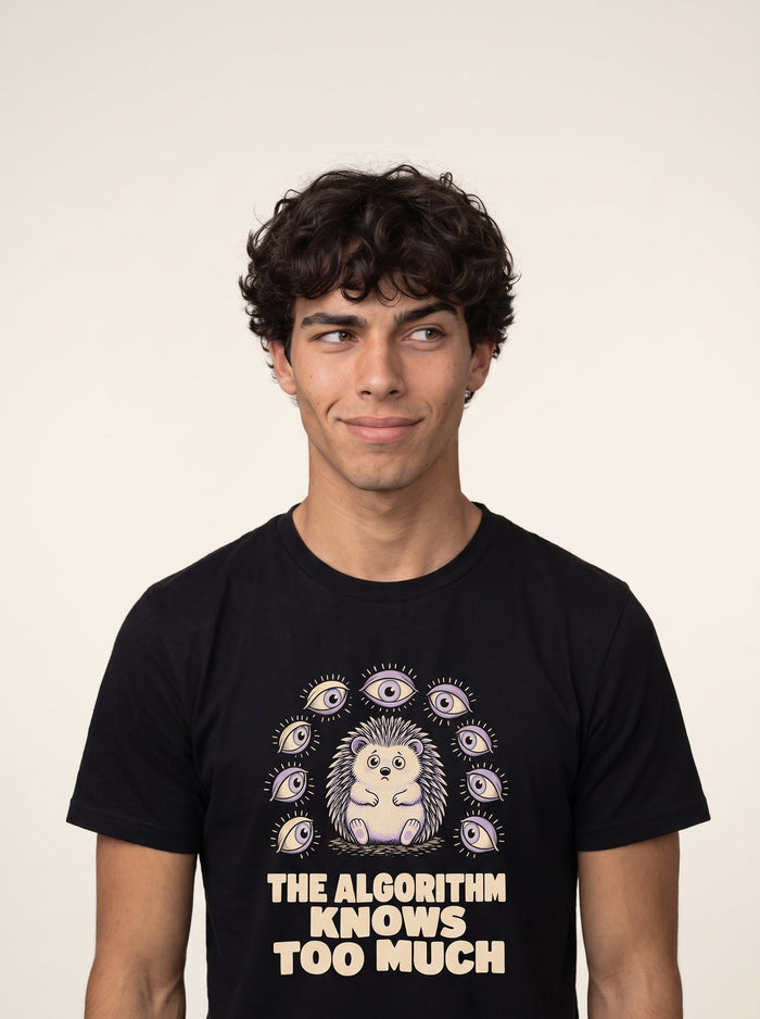 The Algorithm Knows Too Much tee worn front view, black unisex tee, hedgehog ringed by open eyes