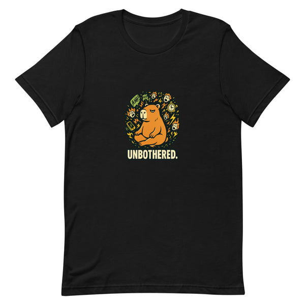 Zen capybara surrounded by chaos, UNBOTHERED text below, on black tee