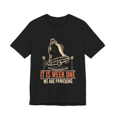 It Is Week One tee flat front, black unisex tee, alarm bell over a stadium