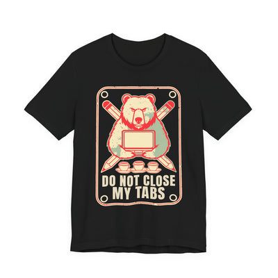 Do Not Close My Tabs tee flat front, black unisex tee, a bear guarding a laptop with pencils crossed behind