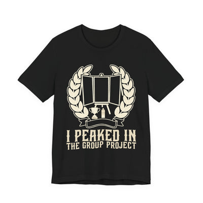 I Peaked In The Group Project tee flat front, black unisex tee, a poster board on an easel in a laurel wreath