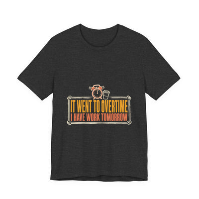 It Went To Overtime tee flat front, dark grey heather unisex tee, a ringing alarm clock beside a coffee cup