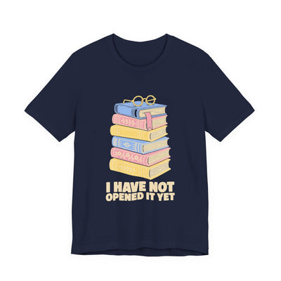I Have Not Opened It Yet tee flat front, navy unisex tee, stack of hardback books