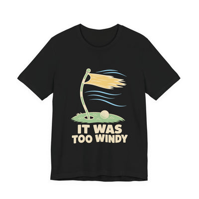 It Was Too Windy tee flat front, black unisex tee, golf flag bent in the wind
