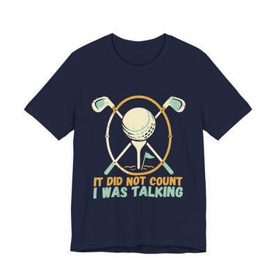 It Did Not Count I Was Talking tee flat front, navy unisex tee, two golf clubs crossed behind a ball on a tee