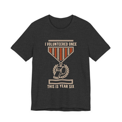 I Volunteered Once tee flat front, dark grey heather unisex tee, coach whistle as a campaign medal