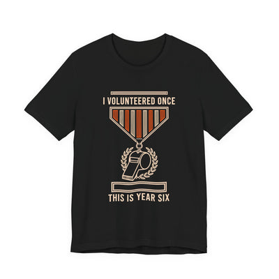 I Volunteered Once tee flat front, black unisex tee, coach whistle as a campaign medal