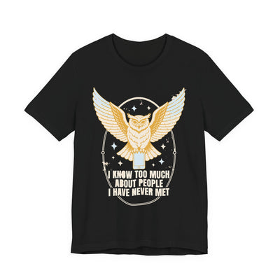 I Know Too Much About People tee flat front, black unisex tee, an owl with wings spread perched on a phone
