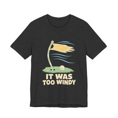 It Was Too Windy tee flat front, dark grey heather unisex tee, golf flag bent in the wind