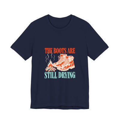 The Boots Are Still Drying tee flat front, navy unisex tee, muddy boots by a campfire