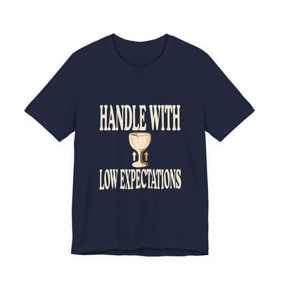 Handle With Low Expectations tee flat front, navy unisex tee, cracked wine glass with arrows