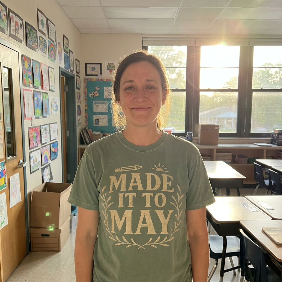 Teacher in sage green Made It To May tee on last day of school, classroom setting, lifestyle shot