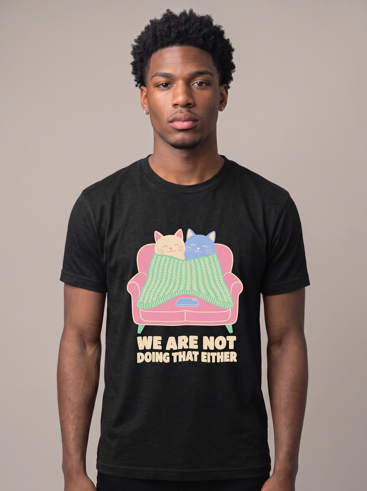 We Are Not Doing That Either tee worn front view, black unisex tee, two cats under a couch blanket