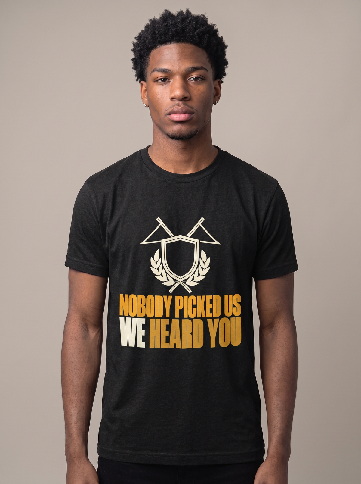 Nobody Picked Us tee worn front view, black unisex tee, crossed pennants and laurel crest