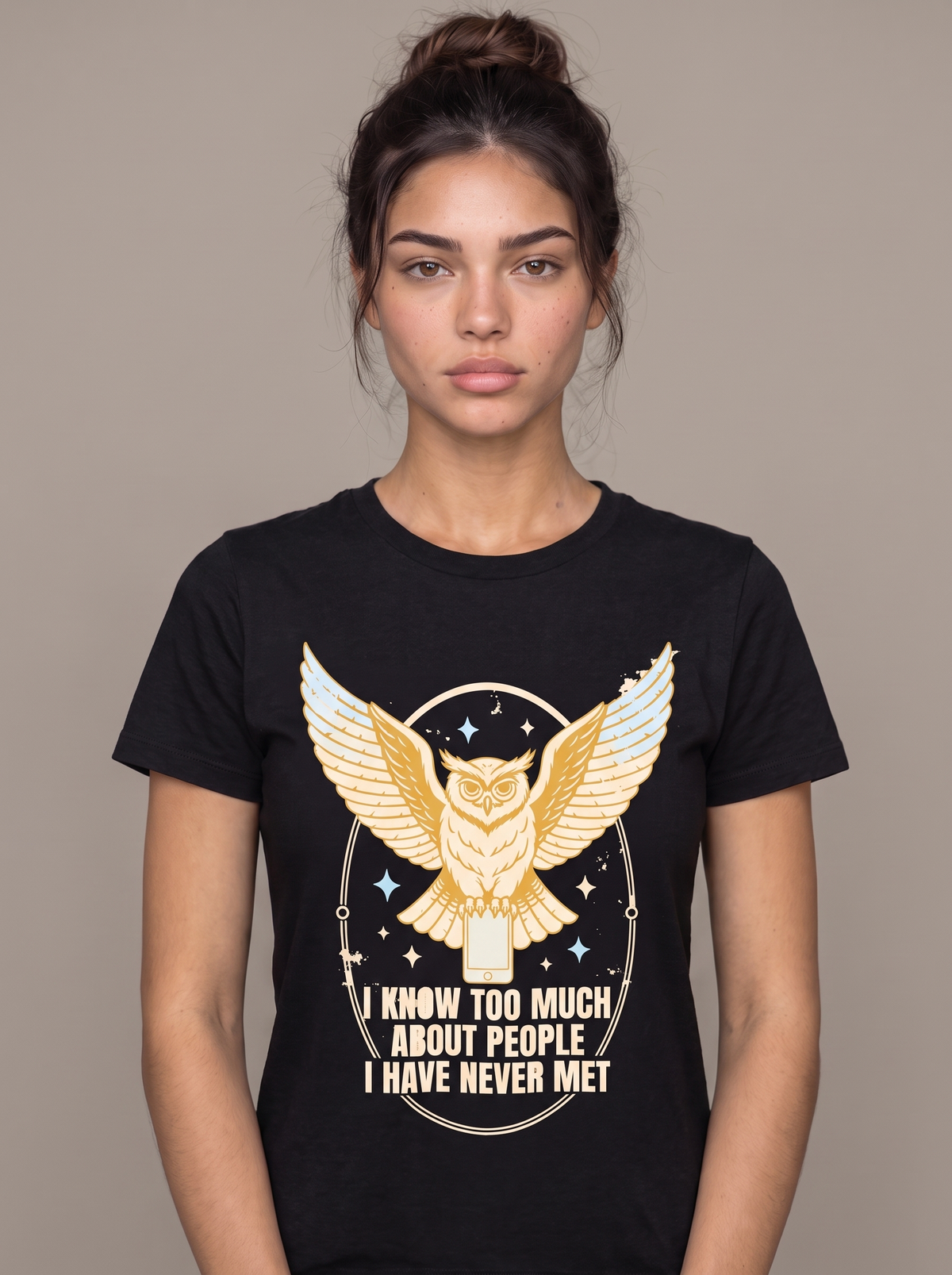 I Know Too Much About People tee worn front view, black unisex tee, an owl with wings spread perched on a phone