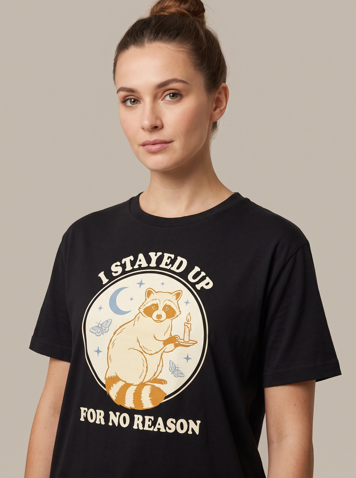 I Stayed Up For No Reason tee worn front view, black unisex tee, a raccoon holding a candle under a crescent moon
