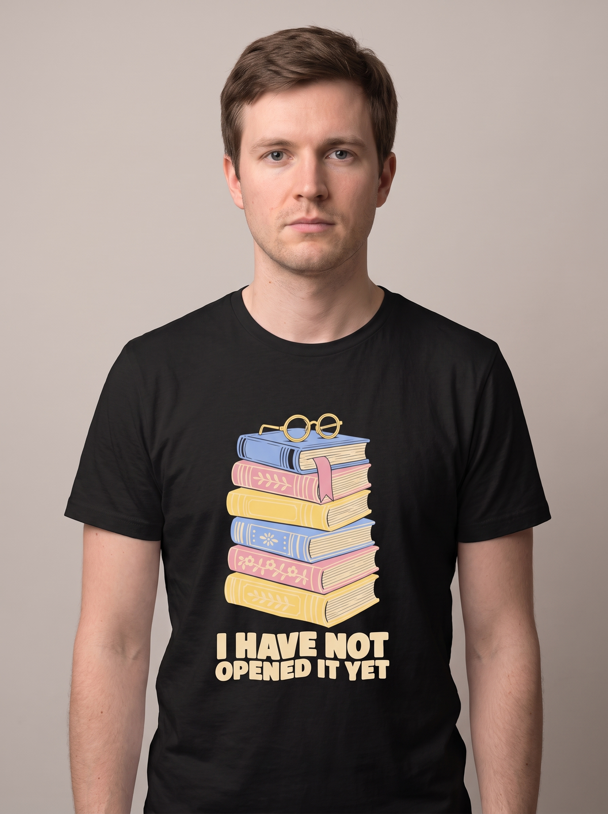 I Have Not Opened It Yet tee worn front view, black unisex tee, stack of hardback books