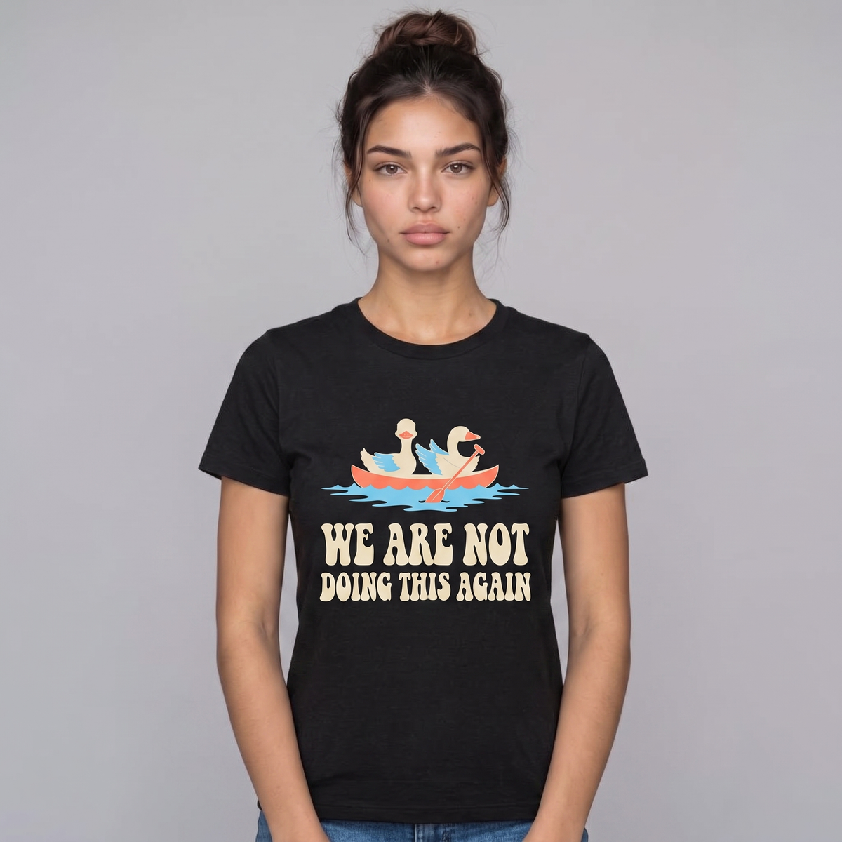 We Are Not Doing This Again tee worn front view, black unisex tee, two geese sharing a canoe