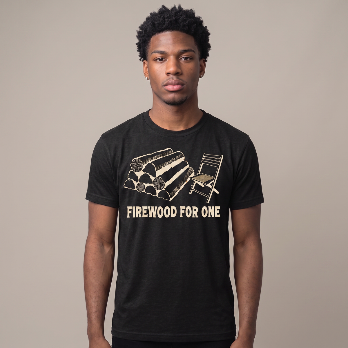 Firewood For One tee worn front view, black unisex tee, stack of split logs beside one folding camp chair